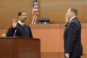 Michael Hughes being sworn into office.